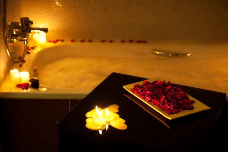 Romantic bathtub ready with candlelight and red petals.  Multiexposure using only candlelight. CANON EOS 5D MarkII