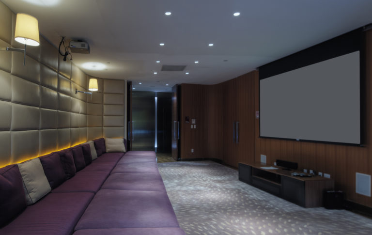 Couch and screen in home theater room
